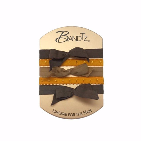 Vivien Set in Brown. Five Bandtz hair bands in three shades of brown. Three stretch hair bows in browns, two dotted hair bands in yellow. 