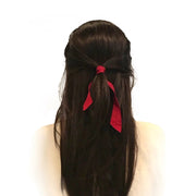 Brunette wearing Bandtz Matte Wide Tail in Red.  